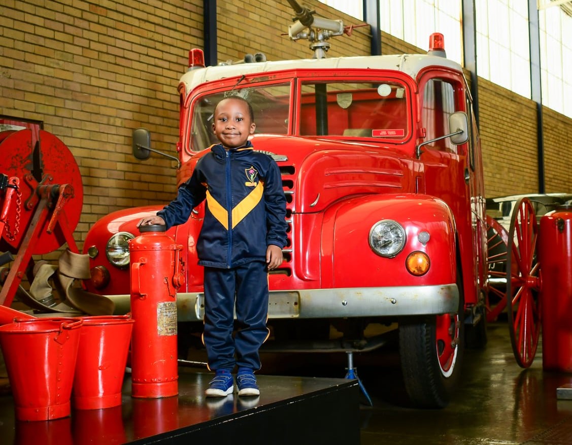 Boy standing in front of truck